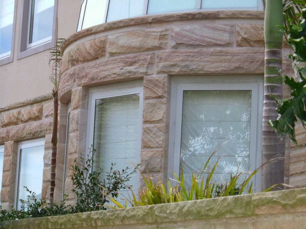Sandstone-clad curved bay windows