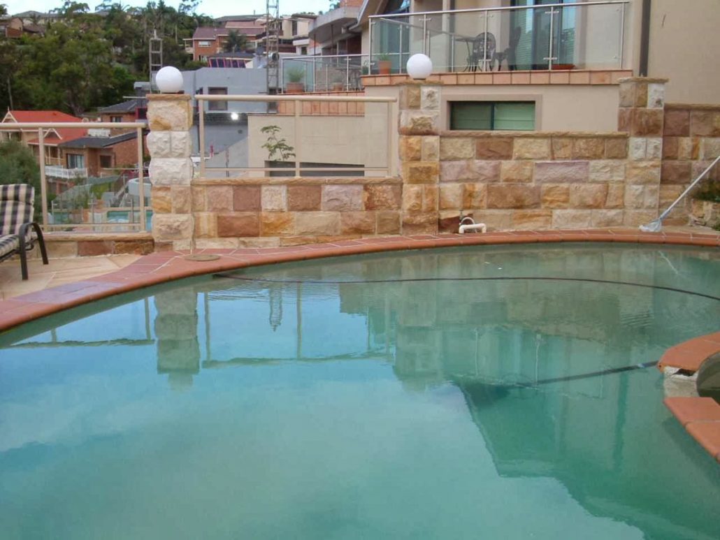 Sandstone wall and capping beside a pool