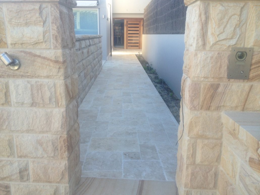 Sandstone paving between stone walls