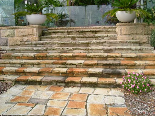 Stone steps with a paved landing and planters