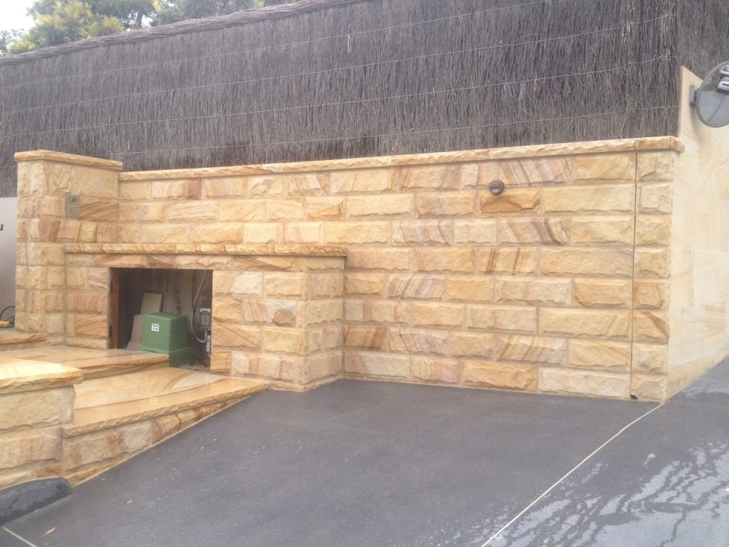 Sandstone wall with a built-in alcove and steps